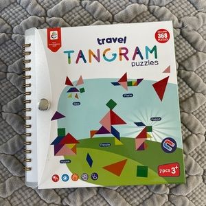 Travel tangrams book and puzzle pieces